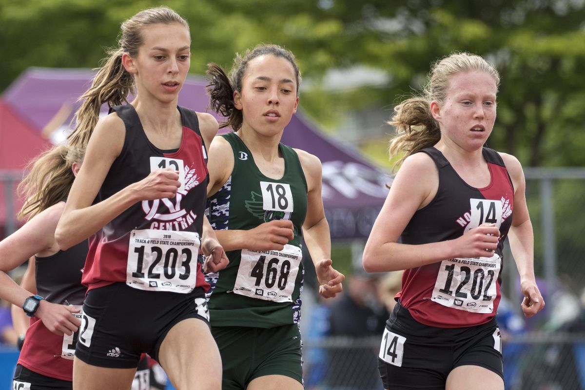 North Central’s Allie Janke, left, and Erinn Hill, right, lead Edmonds-Woodway’s Yukino Parle  around the track in the Stare 3A girls 3,200-meter run Saturday in Tacoma. Parle passed the two late and won the race. Janke placed second and Hill third. (Patrick Hagerty / For The S-R)