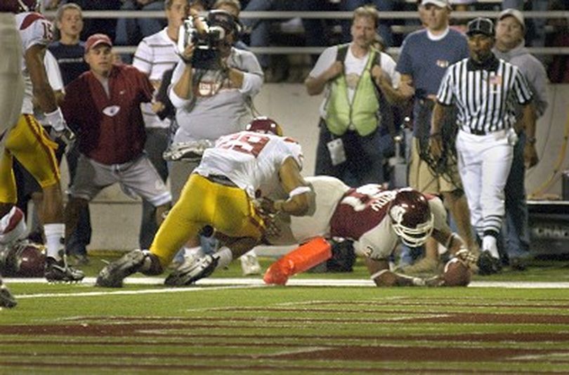 WSU running back Dwight Tardy dives across the goal to score late in the fourth quarter against USC in Martin Stadium Saturday September 30, 2006.  Trying to knock him out of bounds is USC defensive back Taylor Mays.  CHRISTOPHER ANDERSON The Spokesman-Review (Christopher Anderson / The Spokesman-Review)