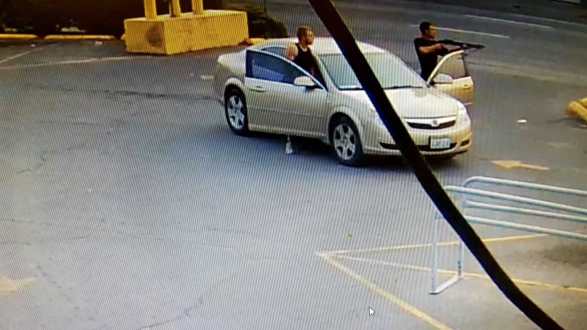 Two men engage in a shouting match while one brandishes a shotgun in this surveillance image captured Sunday, Aug. 6, 2017 in the parking lot of the General Store on North Division Street. (Chad Sokol / The Spokesman-Review)