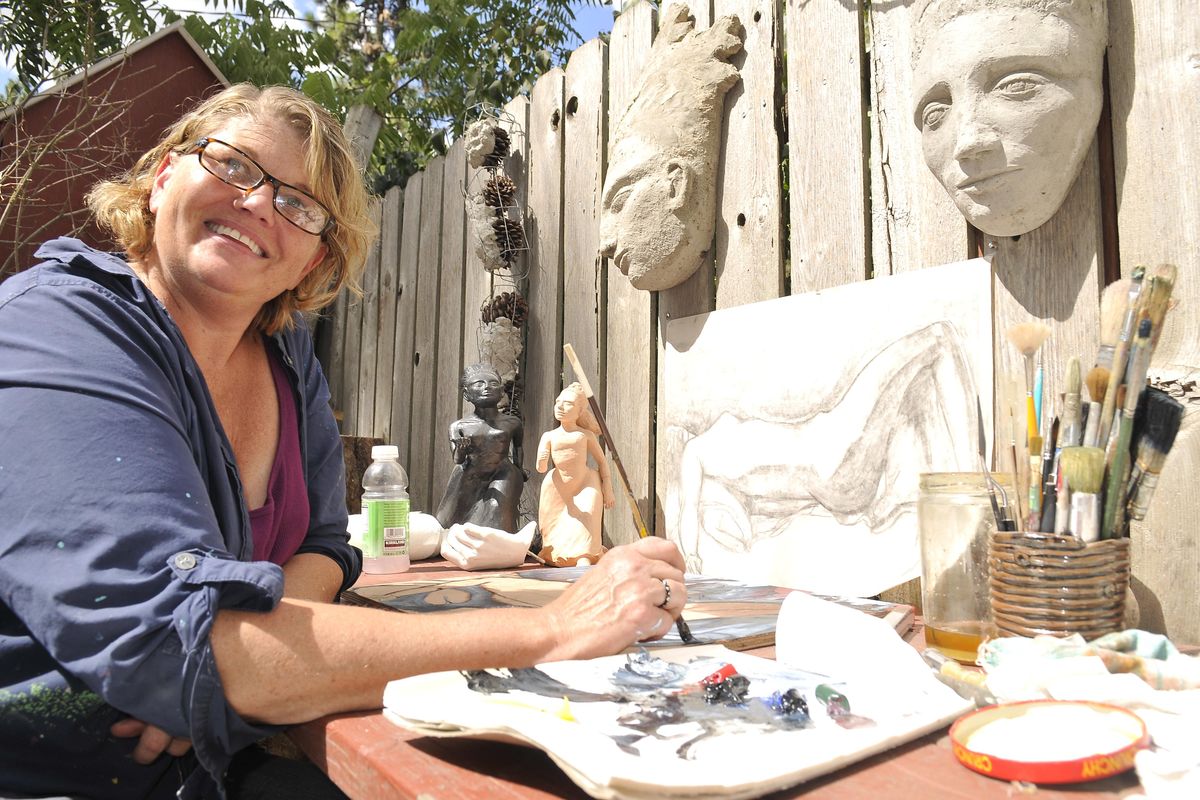 Lea Anne Scott works in her outdoor studio at her south hill home Tuesday, Aug. 23, 2011. She paints and sculpts out of cement and her studio will be on the upcoming artists