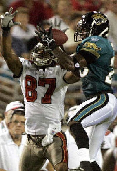 
Jacksonville Jaguars defensive back Dee Webb, right, intercepts a pass  against the Tampa Bay Buccaneers. 
 (Associated Press / The Spokesman-Review)