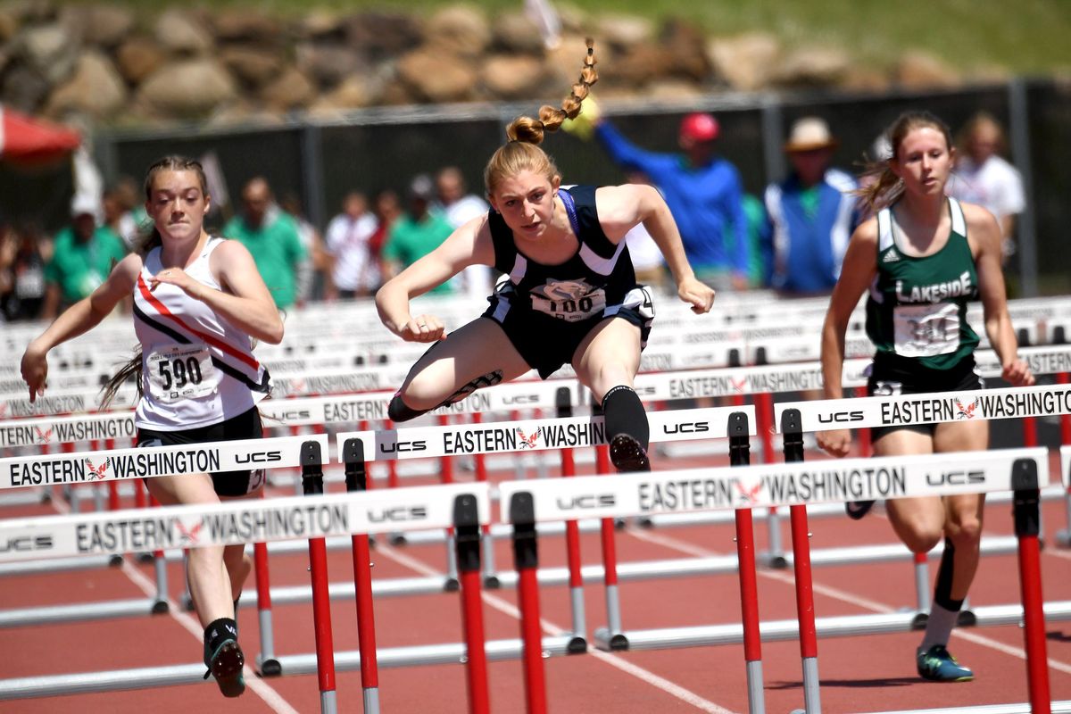 Chewelah’s Lillian Kirry, center, clears a hurdle before winning the State 1A 100-meter hurdles  at Eastern Washington University in Cheney on Saturday. (Kathy Plonka / The Spokesman-Review)