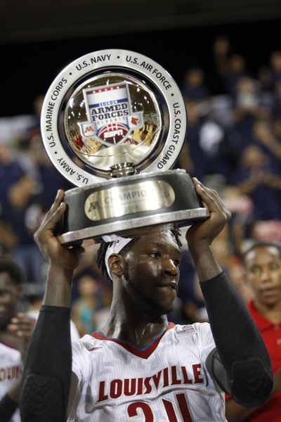 Louisville’s Montrelz Harrell holds up his team's trophy after winning the NCAA college basketball Armed Forces Classic. (Associated Press)