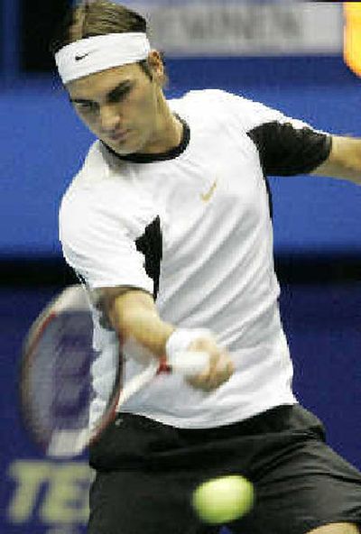 
Roger Federer, hitting a forehand during his victory over Finland's Jarkko Nieminen, advanced to the final of the Thailand Open. 
 (Associated Press / The Spokesman-Review)