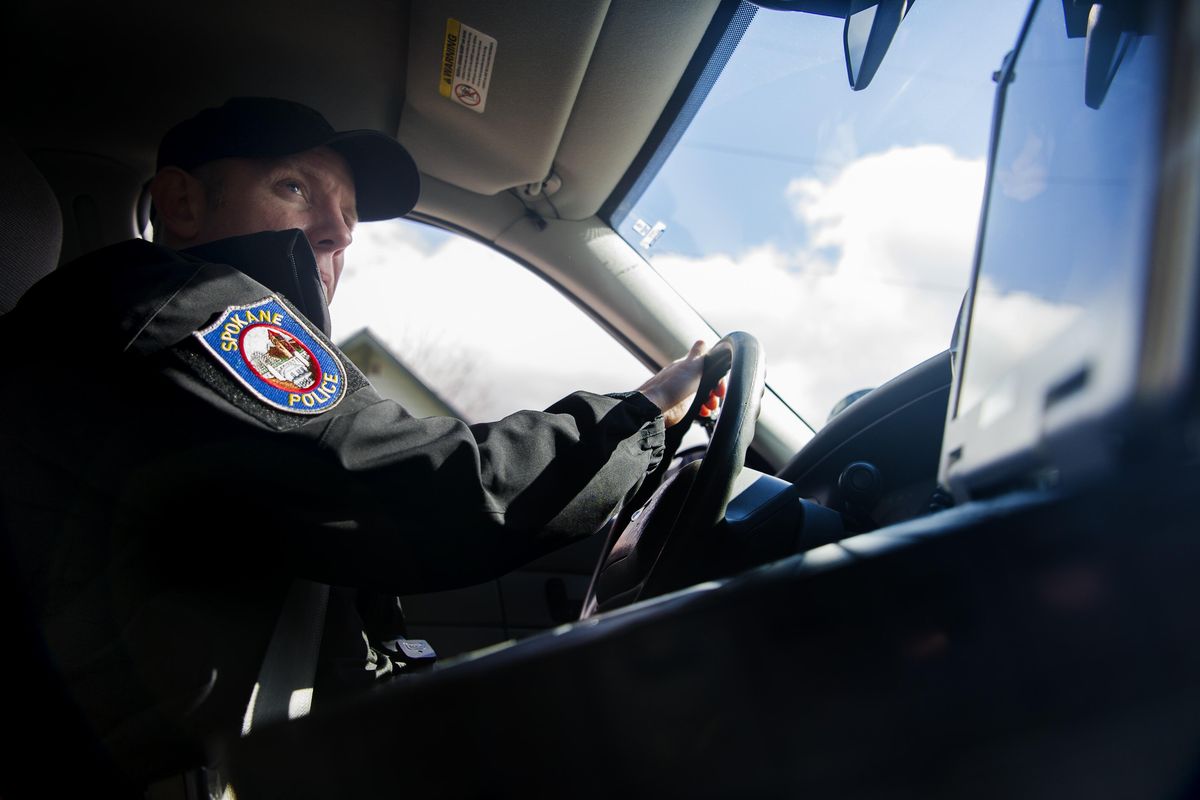 Senior police Officer Nick Geren with the Spokane Police Department’s  domestic violence unit heads to investigate a possible offender while on duty Thursday, March 3, 2016, in Spokane. (Tyler Tjomsland / The Spokesman-Review)