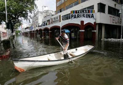 
A man  crosses a flooded avenue in Villahermosa,  Mexico, earlier this month. Associated Press
 (File Associated Press / The Spokesman-Review)