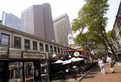 
Shoppers stroll in Faneuil Hall Marketplace Friday in Boston. General Growth Properties Inc. announced it will buy real estate developer The Rouse Co.
 (Associated Press / The Spokesman-Review)