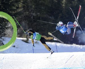 Ted Piccard of France, left and Daron Rahlves of the USA, right crash out during the men's skicross 8th final at the Vancouver 2010 Olympics in Vancouver, British Columbia, Sunday, Feb. 21, 2010. (Mark Terrill / Associated Press)