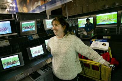 Kelly Hazel of Minneapolis talks with a reporter as she checks out the televisions at a Best Buy store in Roseville, Minn.  
 (Associated Press / The Spokesman-Review)