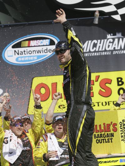Driver Paul Menard celebrates his Nationwide series win at Michigan International Speedway. (Associated Press)