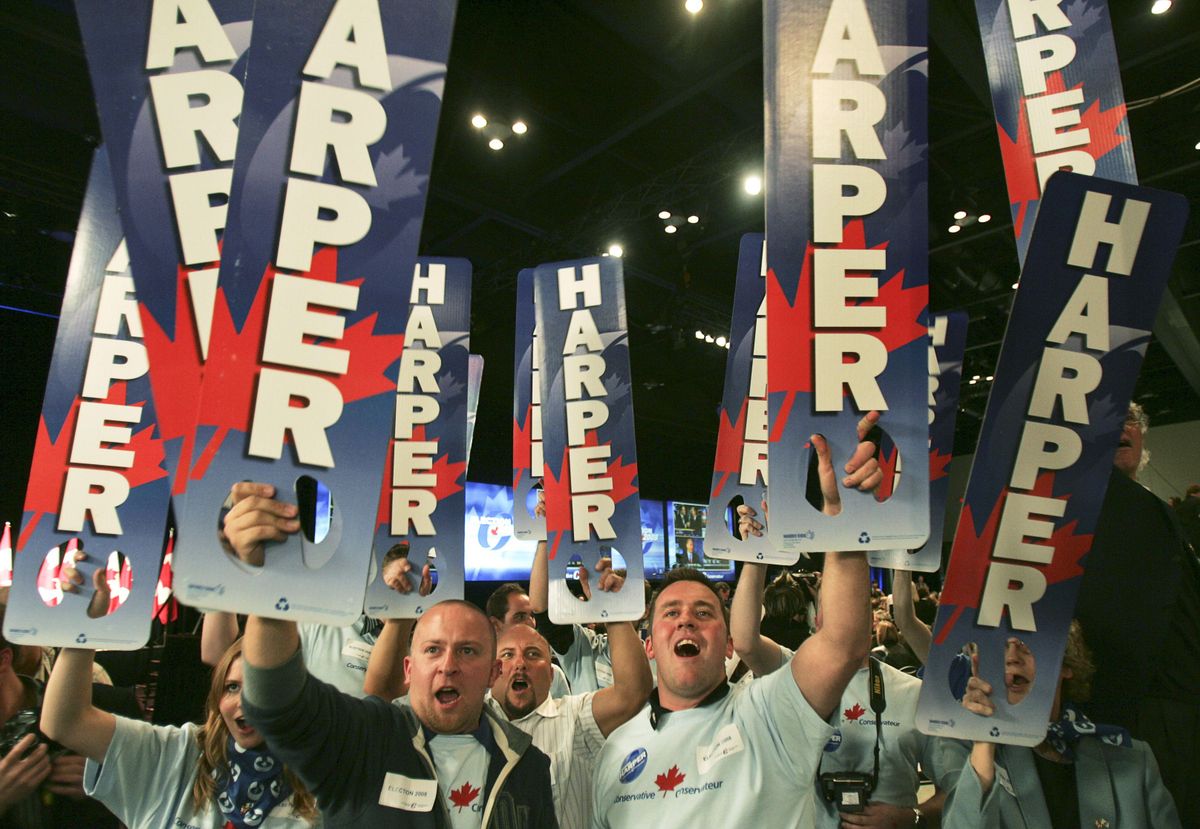 Supporters cheer as results are posted at Conservative leader Stephen Harper’s election headquarters Tuesday in Calgary.  (Associated Press / The Spokesman-Review)