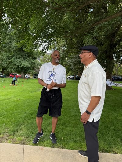 Bobby Jack Sumler (left) catches up with Billy Poindexter (right) during the Our Stories event at the Northwest Museum of Arts and Culture, celebrating community and Black roots in Spokane.  (April Eberhardt/The Black Lens)