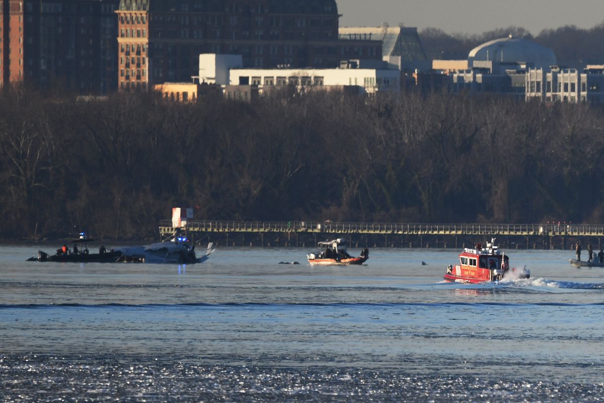 Emergency response units search the crash site near Reagan National Airport last week. MUST CREDIT: Astrid Riecken for The Washington Post  (Astrid Riecken/For The Washington Post)