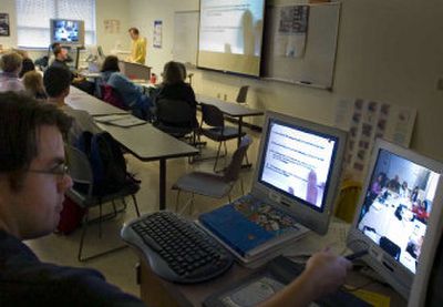 
Spokane Community College student Justin Mapes, left, uses a videoconferencing computer to broadcast a lecture to another class at Tacoma hospital. 
 (Christopher Anderson/ / The Spokesman-Review)