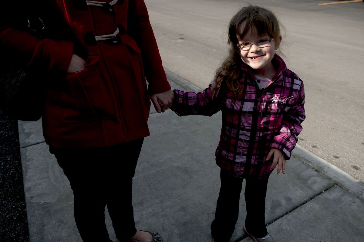 Six-year-old Eden Nagle holds her mother’s hand as she prepares for kindergarten registration at Bryan Elementary School. Eden was born with a rare chromosomal defect discovered through genetic testing (so rare the condition doesn’t have a name). Her parents didn’t know if she