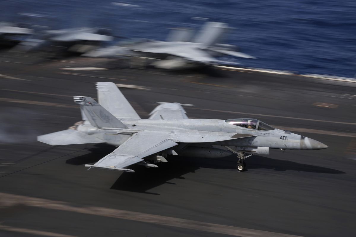 An F/A-18 Super Hornet fighter jet lands Nov. 20, 2018, on the deck of the U.S. Navy USS Ronald Reagan in the South China Sea. (Kin Cheung / AP)