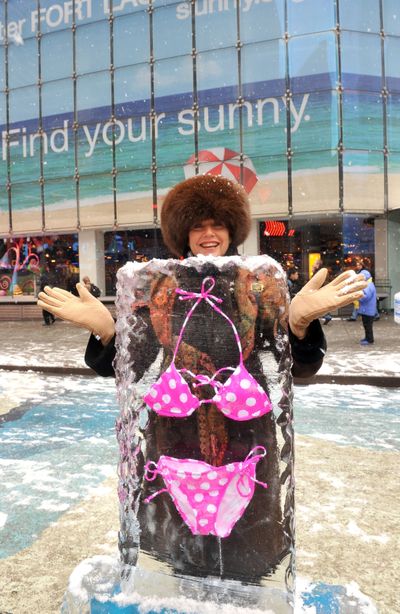 **COMMERCIAL IMAGE** In this photo taken by AP Images for Greater Fort Lauderdale, Virginia Sheridan, of New York, tries on an iced encased bikini displayed in New York's Times Square to lure visitors to 