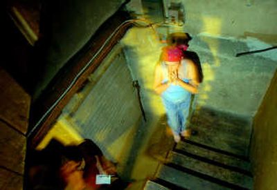 
Carmen Jett, a Spokane resident, stands in the basement of her house, where she's reported seeing a ghostlike figure in recent weeks. Due to an overwhelming fear, Carmen resorted to calling upon SpiritWhispers, a team of local people specializing in 