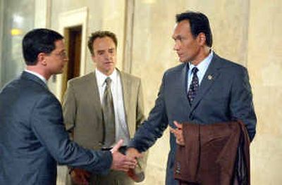 Jimmy Smits, right, shakes hands with Joshua Malina as Bradley Whitford, center, watches in NBC's