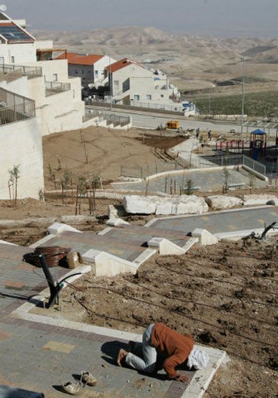 
A Palestinian worker prays  in the West Bank Jewish settlement of Maaleh Adumim on Monday. The Israeli government  has published plans to build 44 homes in  the settlement, violating a pledge to the United States.
 (Associated Press / The Spokesman-Review)