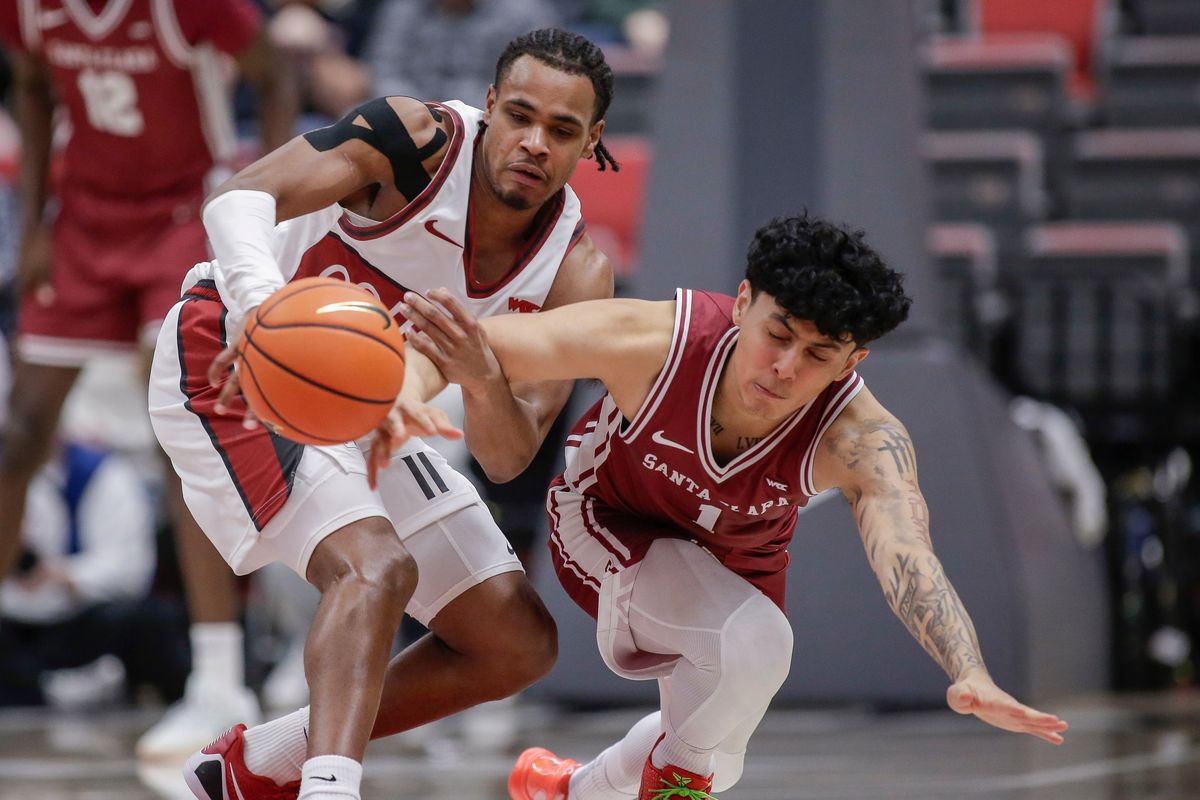 Washington State guard Jerone Morton, left, and Santa Clara guard Christian Hammond reach for a loose ball in the second half on Saturday at Beasley Coliseum in Pullman.  (Geoff Crimmins/For The Spokesman-Review)