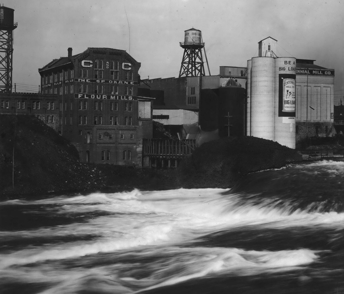 Circa 1910: Spokane Flour Mill, left, and Centennial Mill once sat side-by-side on the north shore of the Spokane River through the 1890s. The Spokane Flour Mill closed in 1972 and was converted to a multiuse building in 1973. Centennial Mill was torn down in 1963 and operations moved to a location on East Trent Avenue, which was built around 1940.  (Frank Palmer/The Spokesman-Review Photo Archive)