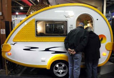 
A retro-style teardrop-shaped trailer gets  close attention at the RV Show  at the Spokane County Fair & Expo Center on Thursday. 
 (Dan Pelle / The Spokesman-Review)
