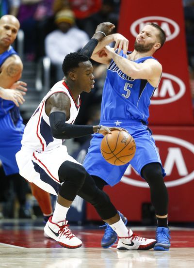 Atlanta guard Dennis Schroder (left) collides with Dallas guard J.J. Barea as he drives in the second half of the Hawks’ 104-87 win. (Associated Press)