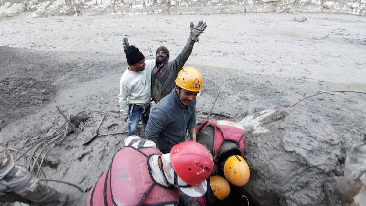 This photograph provided by Indo Tibetan Border Police shows a man reacting after he was pulled out from beneath the ground during rescue operations, after a portion of the Nanda Devi glacier broke off in the Tapovan area of the northern state of Uttarakhand, India, on Sunday.  (HONS)