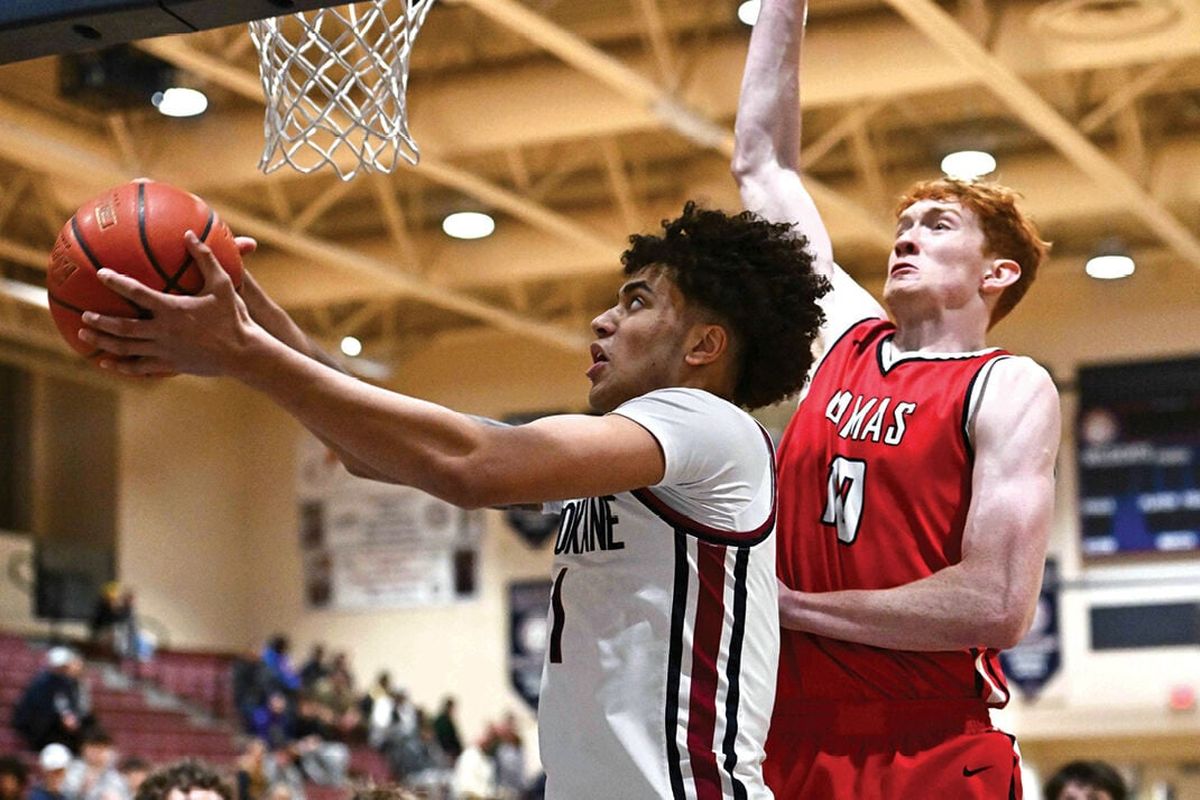 Mt. Spokane forward Jaden Ghoreishi scores against Camas post Ethan Harris in the East vs. West Preseason Shootout on Dec. 6 at Mt. Spokane High School.  (James Snook/For the Spokesman-Review )