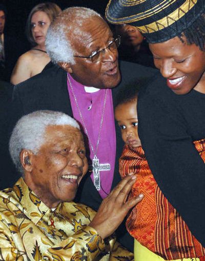 
Retired Anglican Archbishop Desmond Tutu, back left, greets guests with former South African President Nelson Mandela in Johannesburg, South Africa, on Saturday. 
 (Associated Press / The Spokesman-Review)