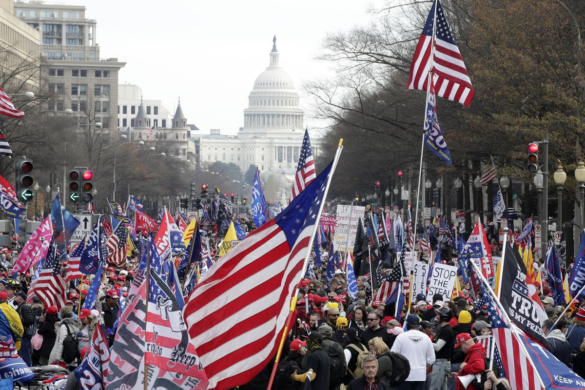 With the U.S. Capitol building in the background, supporters of President Donald Trump stand Pennsylvania Avenue during a rally at Freedom Plaza, Saturday, Dec. 12, 2020, in Washington.  (Luis M. Alvarez)