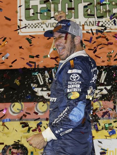 Martin Truex Jr. celebrates in Victory Lane after winning the NASCAR Sprint Cup Series auto race at Darlington Raceway on Sunday, Sept. 4, 2016, in Darlington, S.C. (Terry Renna / Associated Press)