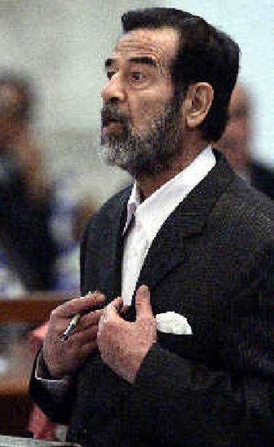 
Former Iraqi President Saddam Hussein speaks in the courtroom to Chief Judge Rizgar Mohammed Amin as his trial resumes in Baghdad on Monday. 
 (Associated Press / The Spokesman-Review)