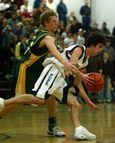 
Shadle's Zach Humphrey reaches around to slip up Gonzaga Prep's Michael Alexander's shot.
 (Amanda Smith / The Spokesman-Review)