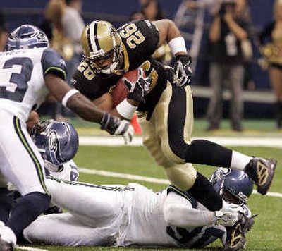 
Saints running back Deuce McAllister steps away from Seahawks defender Marcus Tubbs during the first half. 
 (Associated Press / The Spokesman-Review)