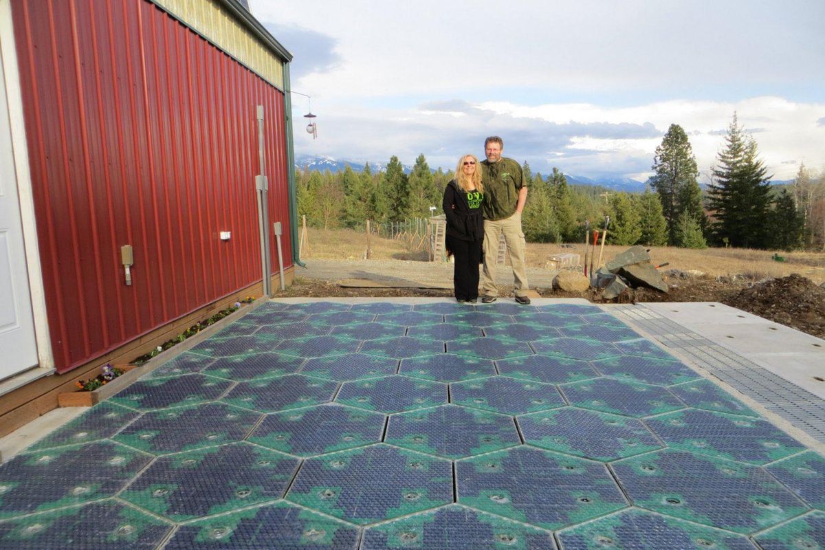 Solar Roadways co-founders Julie & Scott Brusaw stand by a demonstration pad of their solar roadway tiles, which could melt off snow and produce electricity if used in parking lots and roads. (Courtesy Solar Roadways)
