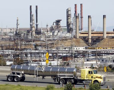 A tanker truck passes the Chevron refinery in Richmond, Calif. (Associated Press)