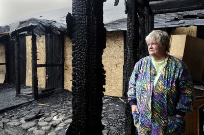 Gloria Bregger stands  amid the ruin of her Spokane Valley home, which burned July 11. She did not have insurance on the tiny rancher she bought in 1973.  (Jesse Tinsley / The Spokesman-Review)