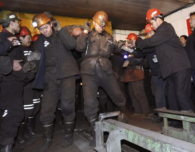 Rescue workers carry the body of a victim at a coal mine in north China’s Shanxi province today. At least 44 miners died and 21 remained trapped underground after a gas blast ripped through the mine.  (Associated Press / The Spokesman-Review)