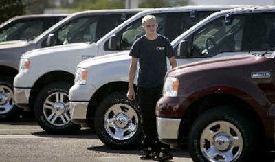 
Lot attendant Eric Garner aligns some Ford F-150s at Pioneer Ford in Goodyear, Ariz. Ford Motor Co. lost $123 million in the second quarter due mainly to the costs of shedding personnel as the nation's second-biggest automaker signaled it plans additional steps in its restructuring effort. 
 (Associated Press / The Spokesman-Review)