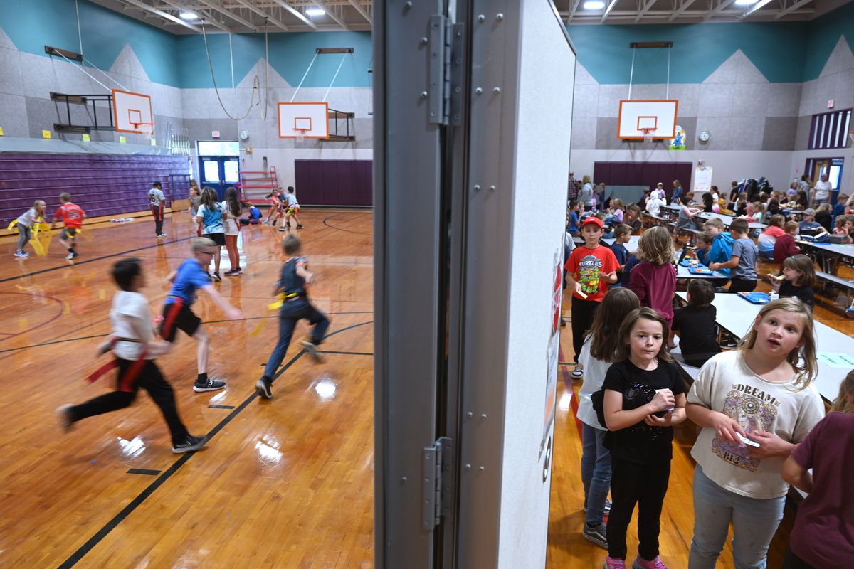 A physical education class takes place Friday at Arcadia Elementary in Deer Park, while students file in for lunch. The gymnasium is divided by a modular wall to make room for a cafeteria-style space in the school which is dealing with an explosion in student population.  (Jesse Tinsley/The Spokesman-Review)