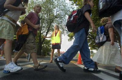 
Kandy Conrad waves a group of students and parents across Grand Boulevard. 
 (Christopher Anderson / The Spokesman-Review)