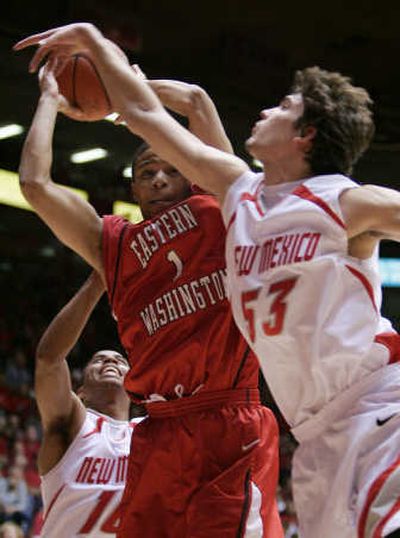 
Eastern's Marcus Hinton is thwarted by New Mexico's Daniel Faris (53). Associated Press
 (Associated Press / The Spokesman-Review)