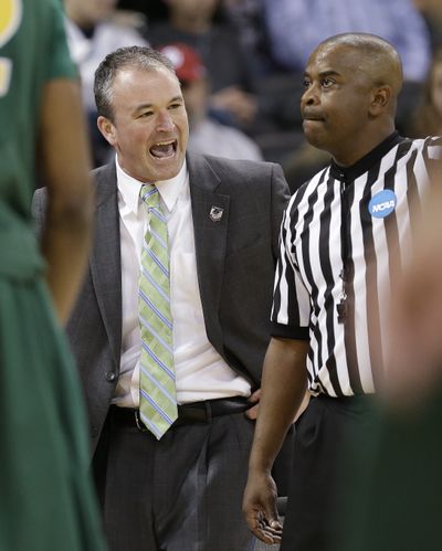 Well, it’s almost a smile on the face of self-described “happy guy” North Dakota State coach Saul Phillips as he talks to official. (Associated Press)