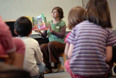 
Monica Smith shows her audience of small children the illustrations while reading a book to them last week. The group was attending story tIme at the Spokane Public Library South Hill branch at 33rd Avenue and Perry Street. 
 (CHRISTOPHER ANDERSON / The Spokesman-Review)