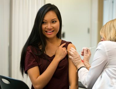 Hanh To, pharmacy student at WSU, prepares herself for a flu shot from second year pharmacy student MaryAnne Gellings in 2015 at the school’s south campus facility in Spokane.  (DAN PELLE/The Spokesman-Review)