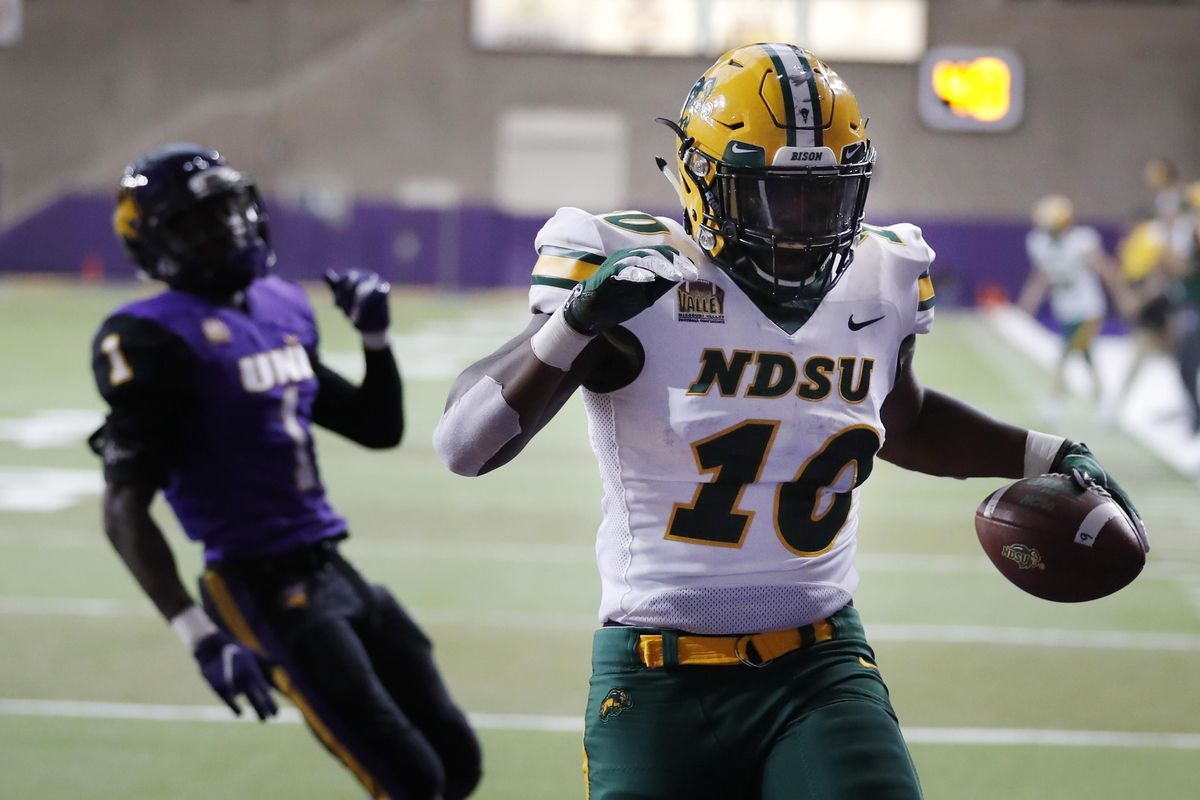 North Dakota State running back Lance Dunn  celebrates in front of Northern Iowa defensive back Roosevelt Lawrence after catching a 3-yard touchdown pass during the first half  Oct. 6  in Cedar Falls, Iowa. (Charlie Neibergall / AP)