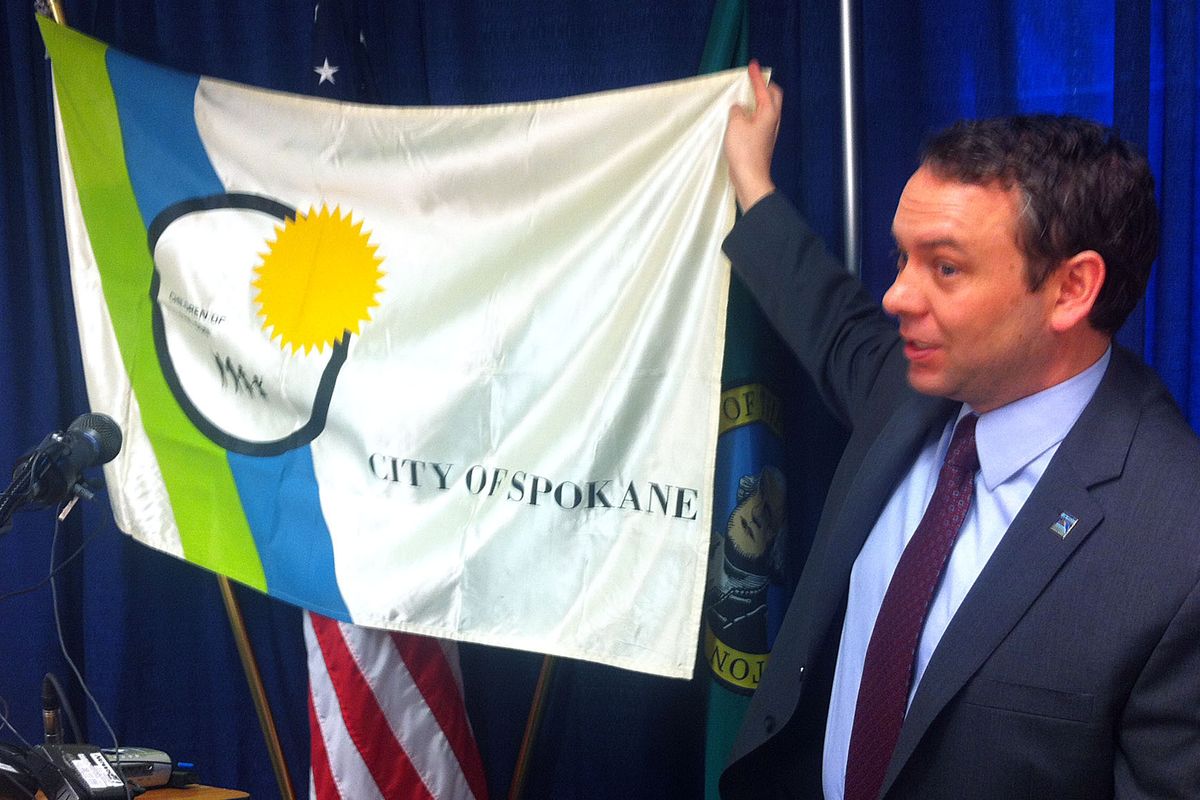 Spokane Mayor David Condon shows off the city of Spokane’s official flag at a news conference on Tuesday. (Jonathan Brunt)