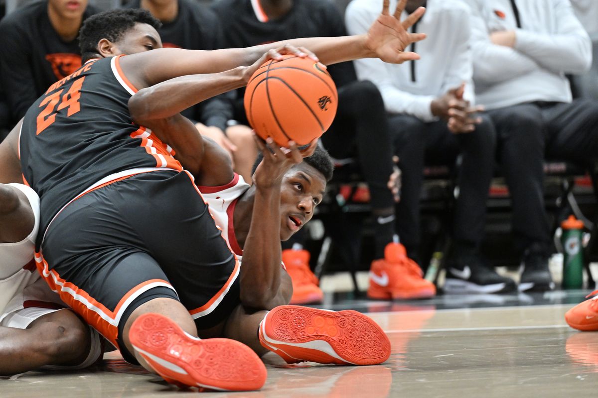 Washington State center Rueben Chinyelu fights for a loose ball against Oregon State on Thursday at Beasley Coliseum in Pullman.  (Courtesy of WSU Athletics)